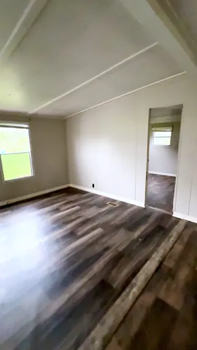 Living room with plank floors and a large window