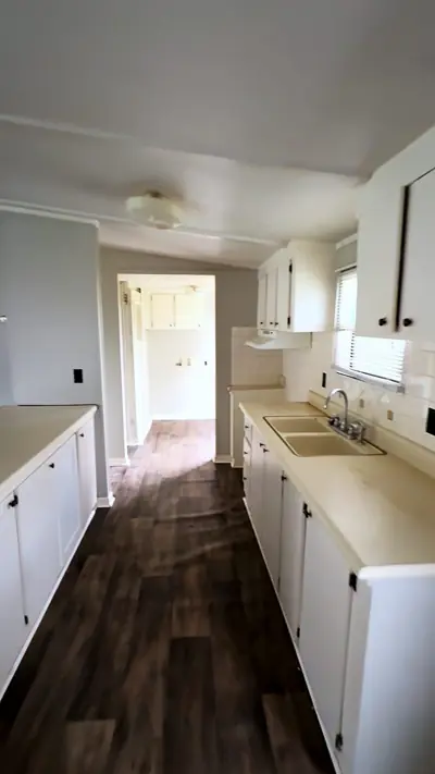 White kitchen with an island and double stainless sink