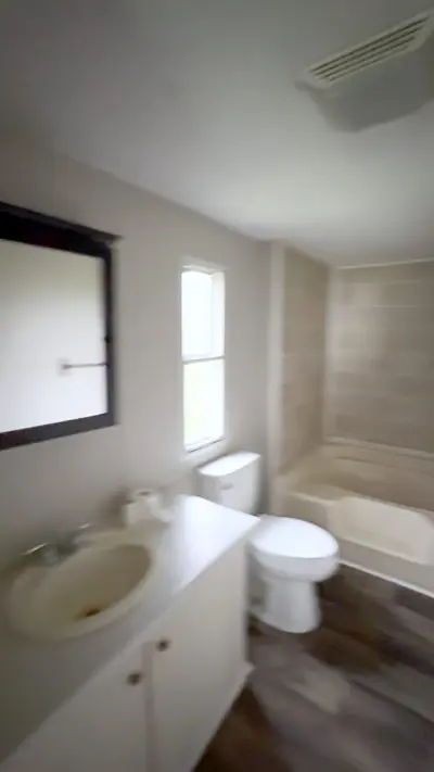 Master bath with vanity and tiled tub surround