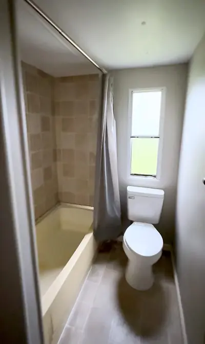 Hall bath with tiled tub and shower